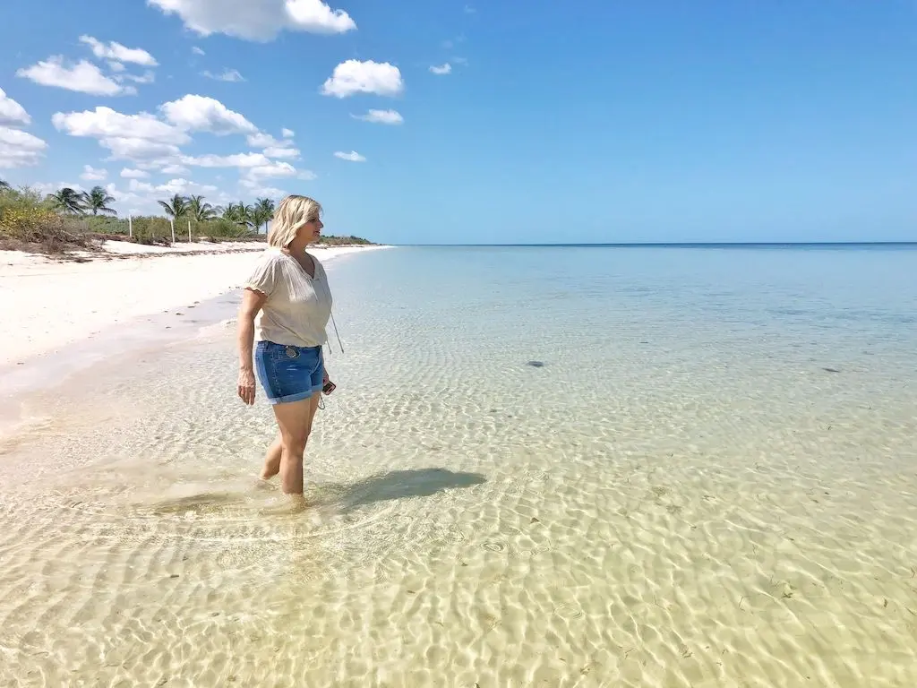 Woman standing in the ocean on the gulf coast of Mexico in Yucatan.